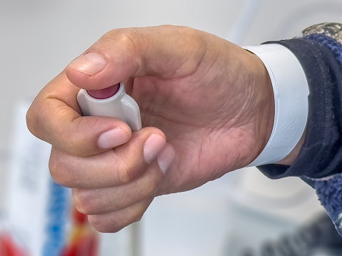 In a hospital room, a patient conscientiously utilizes the emergency nurse call button device, ensuring prompt access to essential medical assistance, Nurse Call Button Cord