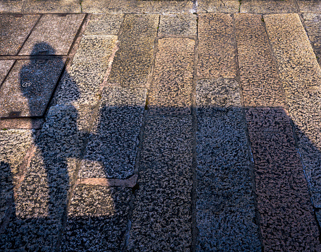 Ghost shadow standing on black brick wall