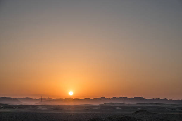 istock warm bright sun with mountains in the desert during sunset 2044675522