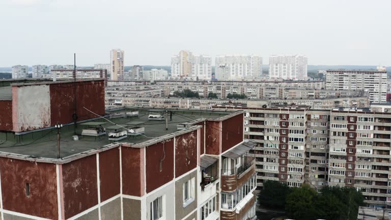 View of a typical residential multi storey building in a city sleeping area. Stock footage. Old panel apartment with windows and balconies.