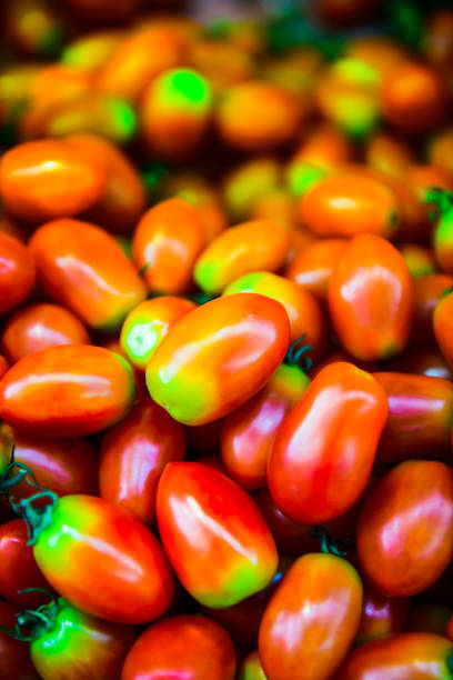 A lot tomatoes holding in hands at the market