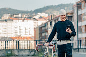 young man with bicycle and mobile phone on the street