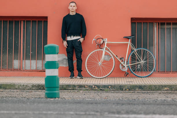istock young man with bicycle on street 2044715513