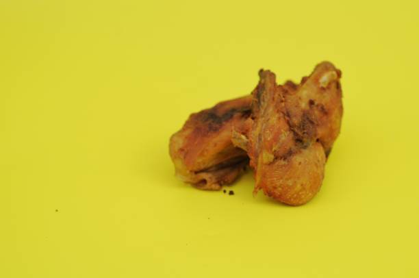 istock fried chicken on a plate on a yellow background 2044736057