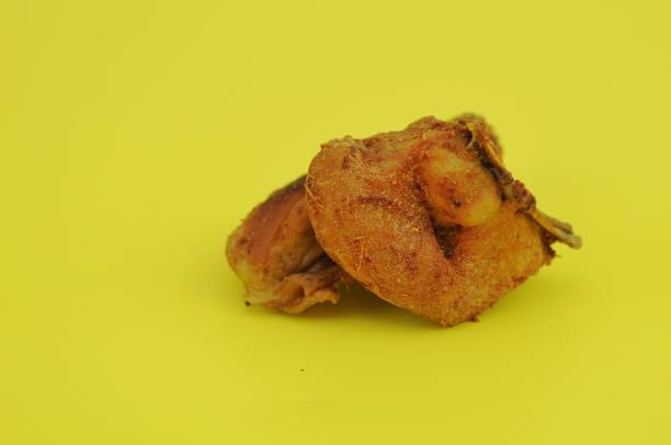 istock fried chicken on a plate on a yellow background 2044736070