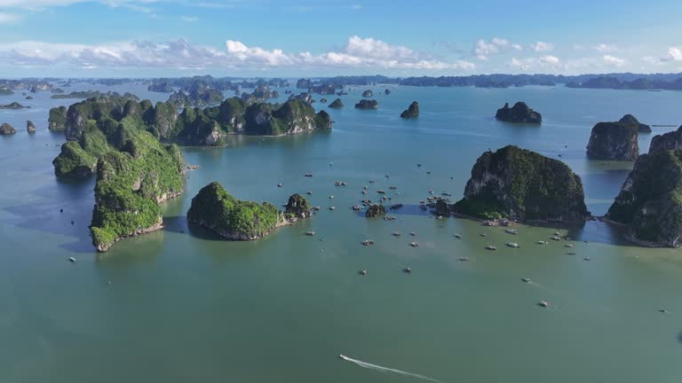 Aerial Drone Sunset Scene of Rock Mountain on the sea at Ha Long bay with ha Long City, North of Vietnam