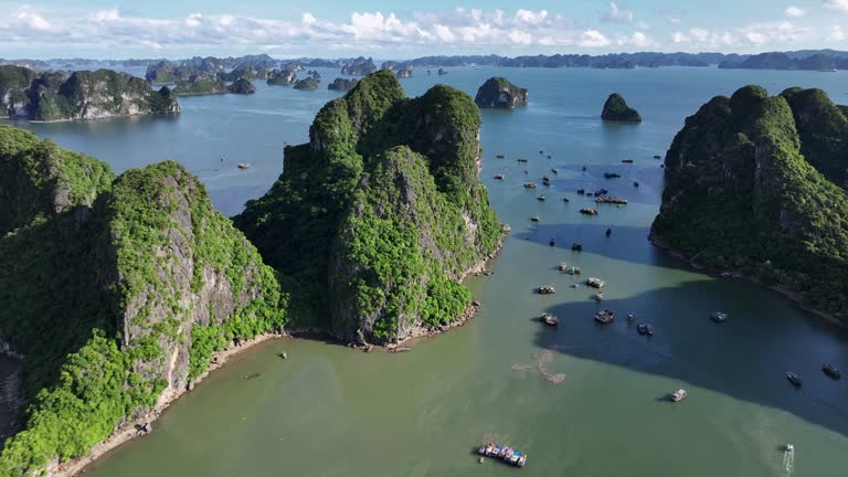 Aerial Drone Sunset Scene of Rock Mountain on the sea at Ha Long bay with ha Long City, North of Vietnam