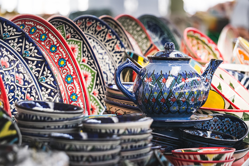 Multi-colored ceramic products with oriental ornaments at the Siab Bazaar in the ancient city of Samarkand in Uzbekistan, Siyob bozor