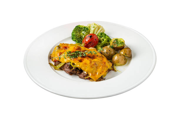 istock Cheddar cheese beefsteak with potatoes and broccoli on white background 2044765465