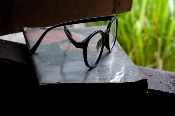 The glasses beside the book were removed to give the eyes a rest.
