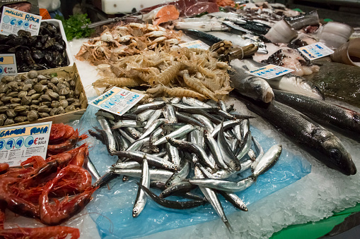 Horizontal view of the merchandise of a fish stall in the old Abaceria Central Market of the Gracia neighborhood in Barcelona