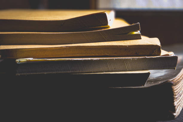 istock A stack of books in a dark place exposed to light from a window 2044797698