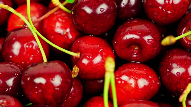 Fresh Ripe Cherries With Water Droplets Rotating In A Bowl