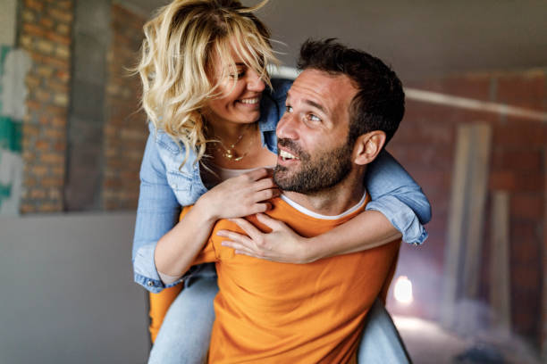 istock Carefree couple having fun while piggybacking at construction site. 2044809382