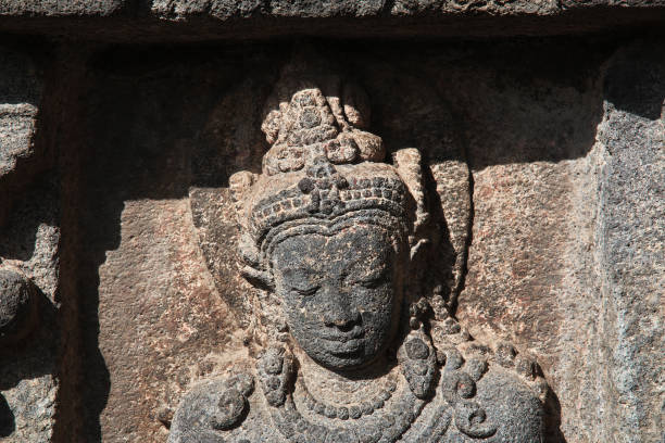 Bas-relief sculptures on wall at encased foot of Borobudur, Indonesia