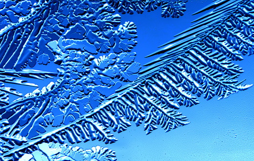 Drawings of ice on blue glass. Abstract background
