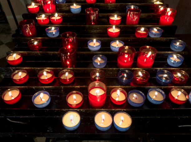 Close up praying candles in church in France