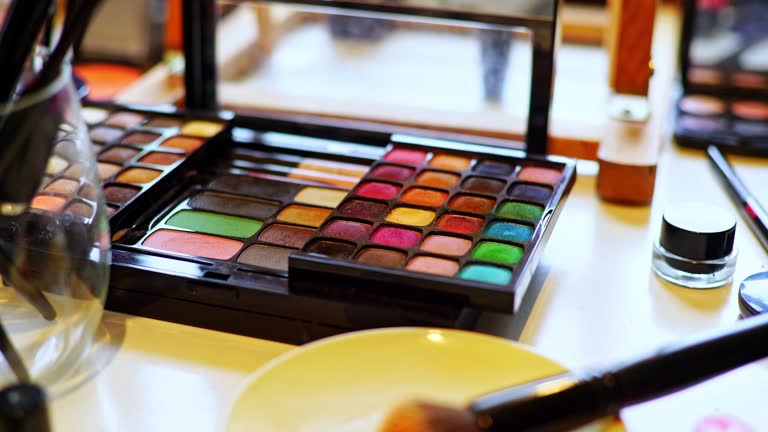 A Set Of Makeup Brushes, Beauty Products And Eyeshadow Palette Arranged On A Desk At The Beautician's Salon