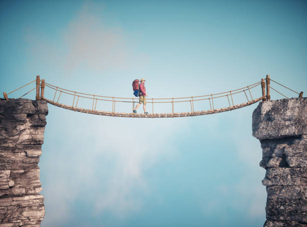 istock Man walking on a rope suspension bridge. Travel concept 2044846376