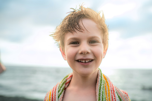 Cute little boy near the sea on beach holidays