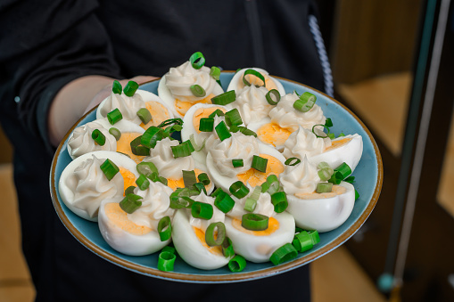 Traditional Easter eggs in mayonnaise with chives on a plate