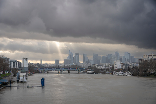 Gennevilliers, France - 02 11 2024: Panoramic view of the Seine river and La Defense towers district from Clichy bridge at sunset