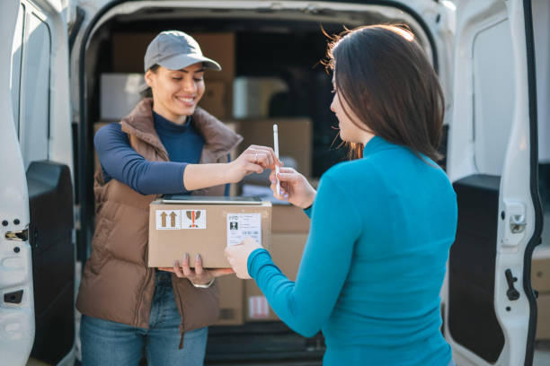 istock Female worker is delivering parcel to customer. 2044894308