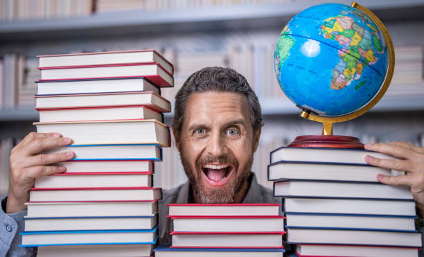 istock bookworm in school library. education and knowledge. man teacher in class. school education. man nerd with school book. school literature education. nerd man in classroom. world through reading 2044906388