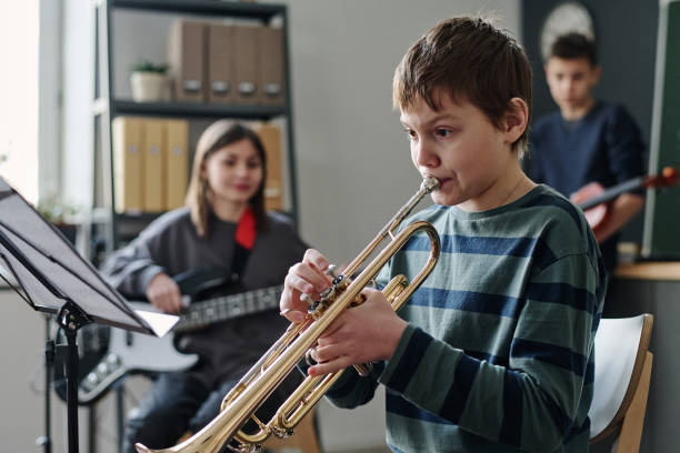 istock Boy Playing Trumpet In School Orchestra 2044906934