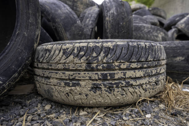 Detail of old damaged and worn car tire, recycling