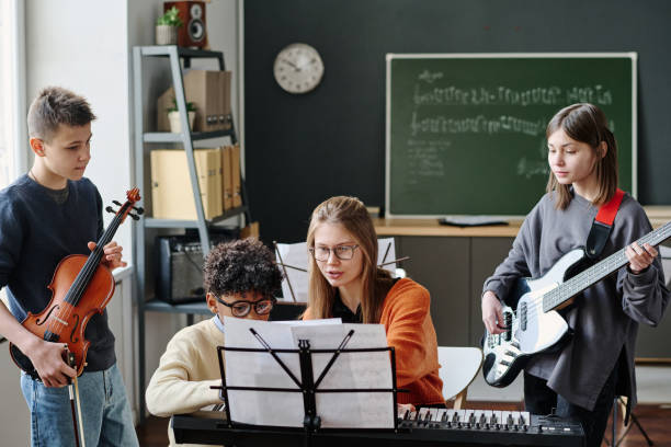 istock Young Music Teacher Working With School Band 2044929794