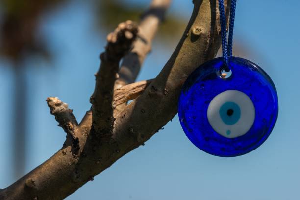 istock Closeup of an evil eye trinket on a tree branch 2044935636