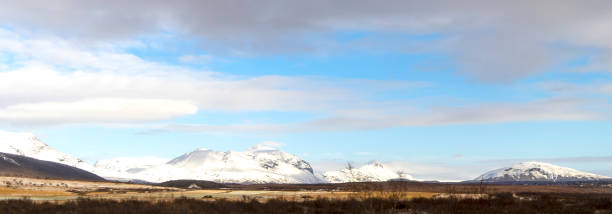istock Landscape with grass and ice capped mountains 2044939384