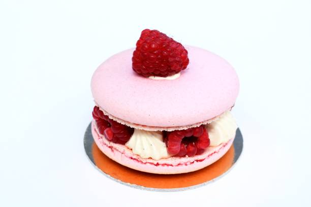 Delicious big macaron with fresh raspberries and butter vanilla cream