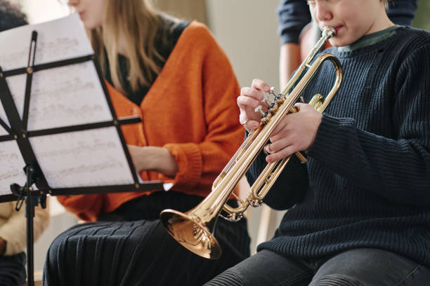 istock Kid Playing Trumpet In School Orchestra 2044939936