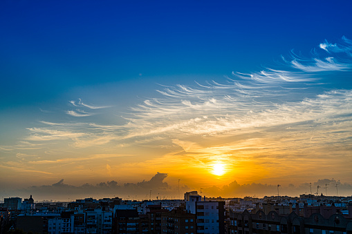 Beautiful sunset or sunrise with cirrus clouds over the city