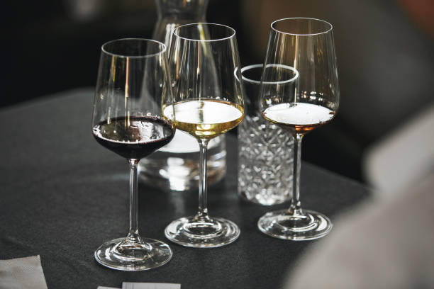 istock Elegant wine glasses with different white and red wines on the table during the preparation for the tasting. 2044944798