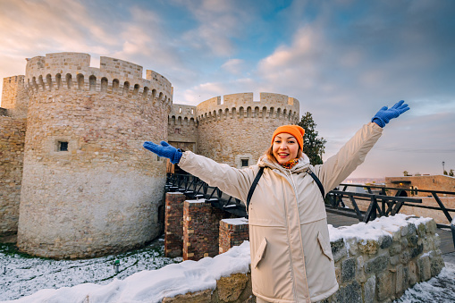 Happy tourist girl at the Zindan gate entrance to Kalemegdan fortress. Travel attractions and destinations in Belgrade