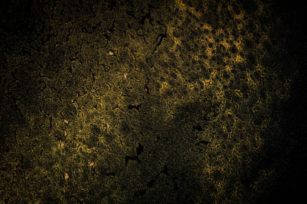Dark background with glitter ink in gold color makes wallpaper.