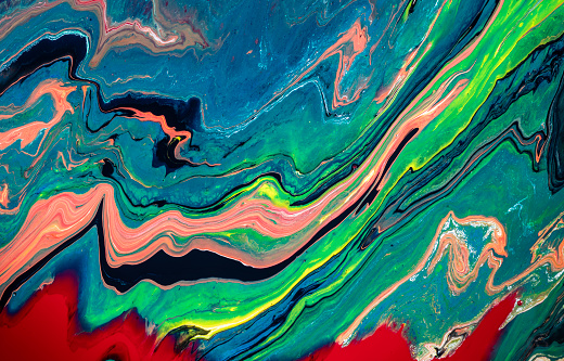 Colorful acrylic pouring inks making abstract art wallpaper.