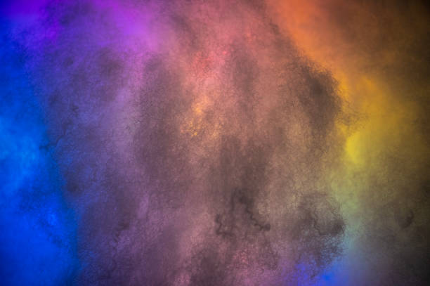 Different colors crossing through clouds making abstract wallpaper.