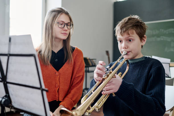 istock Boy Playing Trumpet At Music Class 2044957126