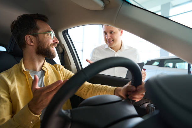 istock Buyer in a car is studying functionality of popular model 2044957181