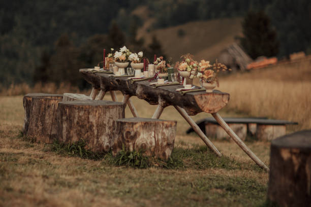 istock Stylized wedding table outside with candles and cutlery. 2044978450