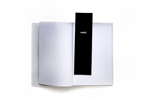 A hardcover book with black bookmark labeled READ