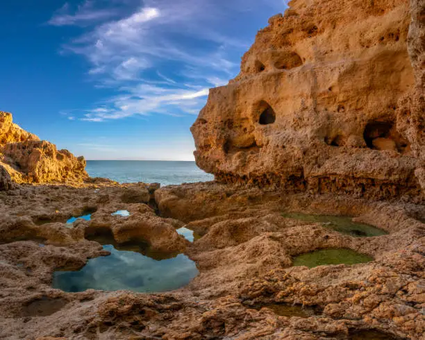 Photo of Sculptural rock formations, natural caves and tidal pools on the shores of the Atlantic ocean, Algar seco, Carvoeiro, Lagoa, Algarve, Portugal.