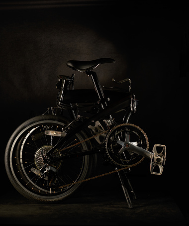 Folding bicycle isolated on dark or black