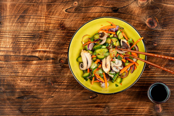 Salad of cucumber, onion and octopus. Space for text. Korean cuisine with seafood