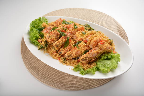 istock chef cook wok fried big tiger prawn with crispy butter cereal curry leaf chilli in plate on white table seafood restaurant asian cafe halal chinese banquet menu 2044999808