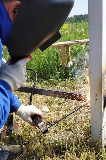 istock At the construction site, the master welds a metal profile for the fence. 2045011775